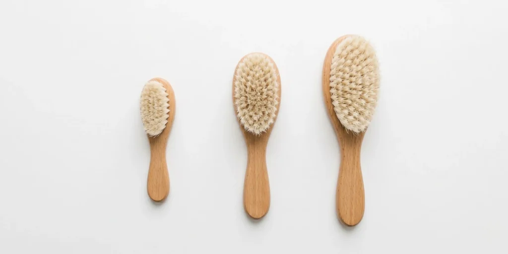 Baby and toddler hair brushes showing age-appropriate specifications from newborn soft bristle to toddler detangling brush