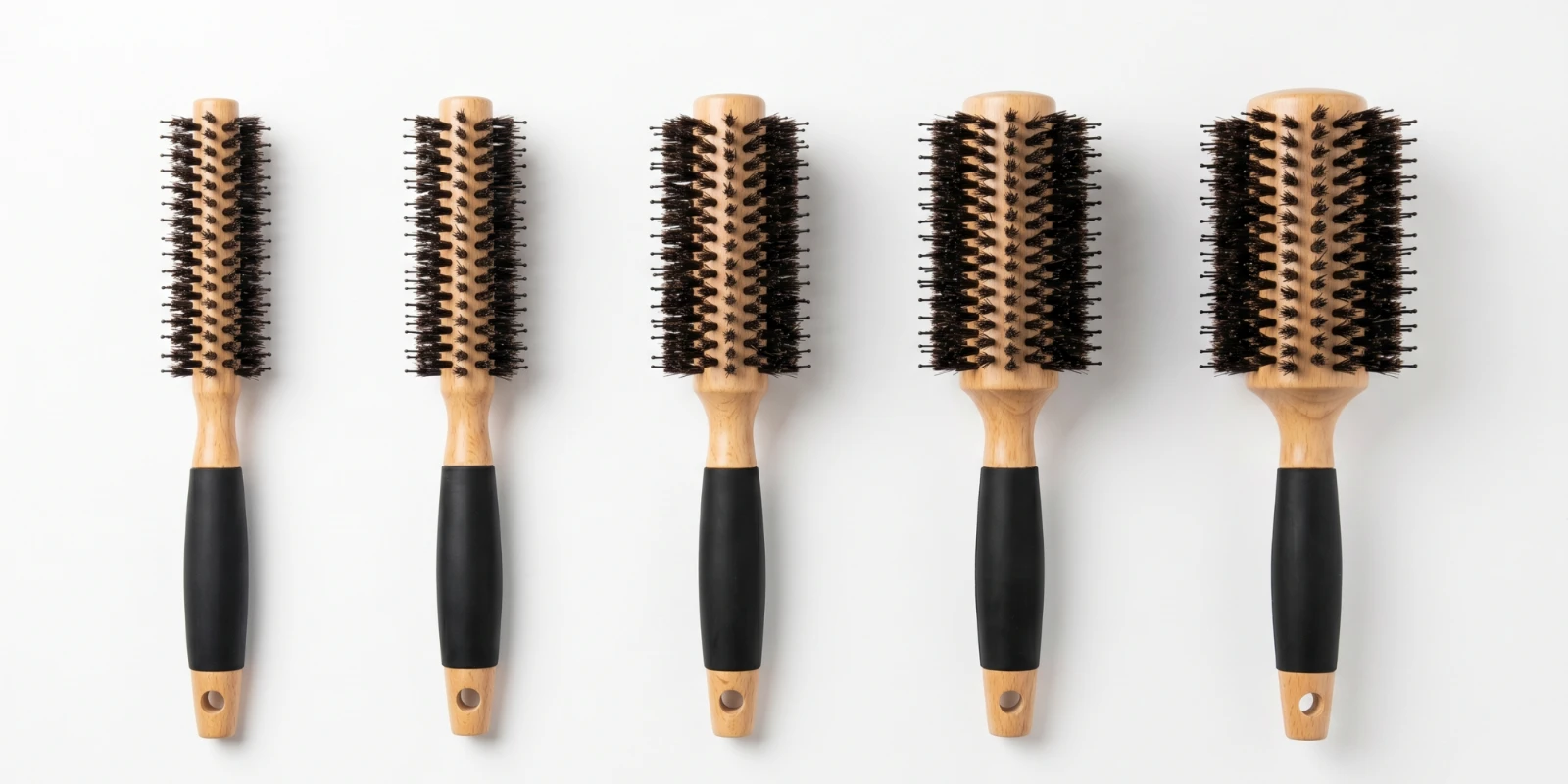Round hair brushes with boar and nylon bristles and wooden handles in different barrel sizes
