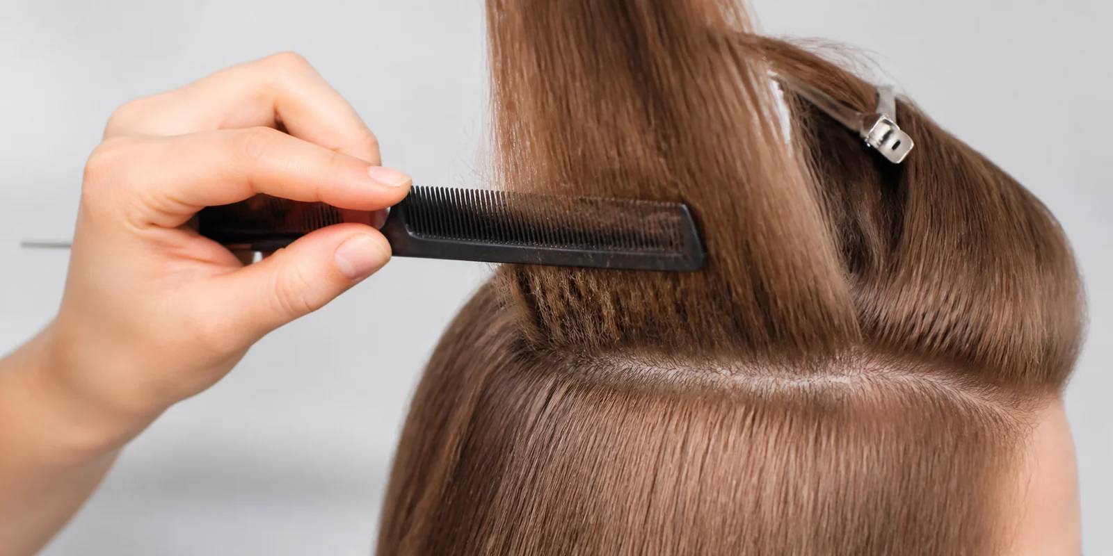 Correct backcombing technique using a teasing comb in short strokes toward the root for volume