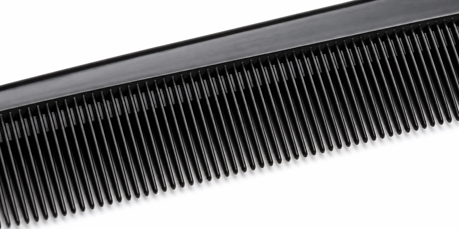 Close-up of fine dense teasing comb teeth showing the tight spacing that creates the backcombing volume mechanism