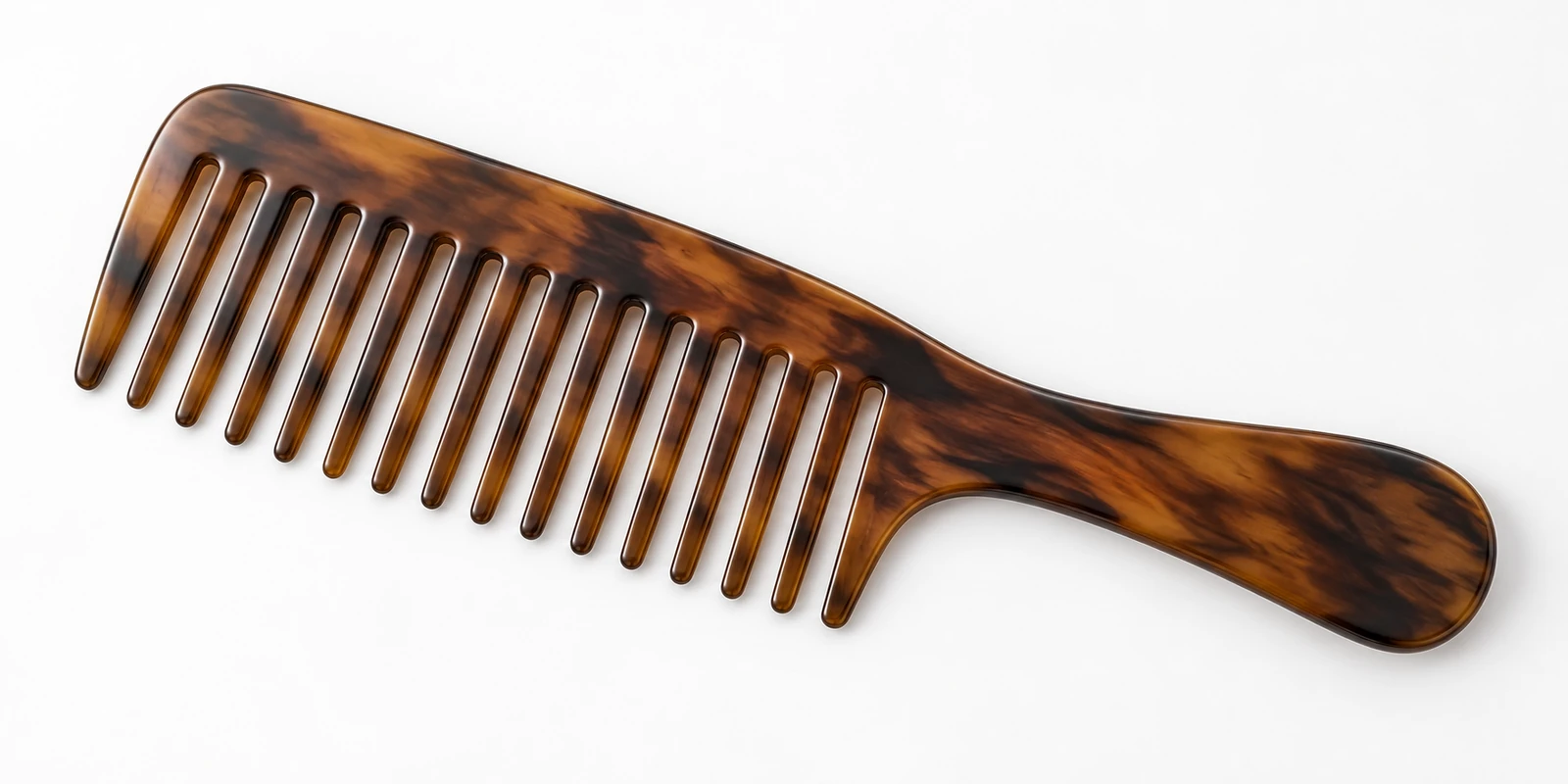 Wide flat curl defining comb shown for shaping curly hair with definition and minimal frizz