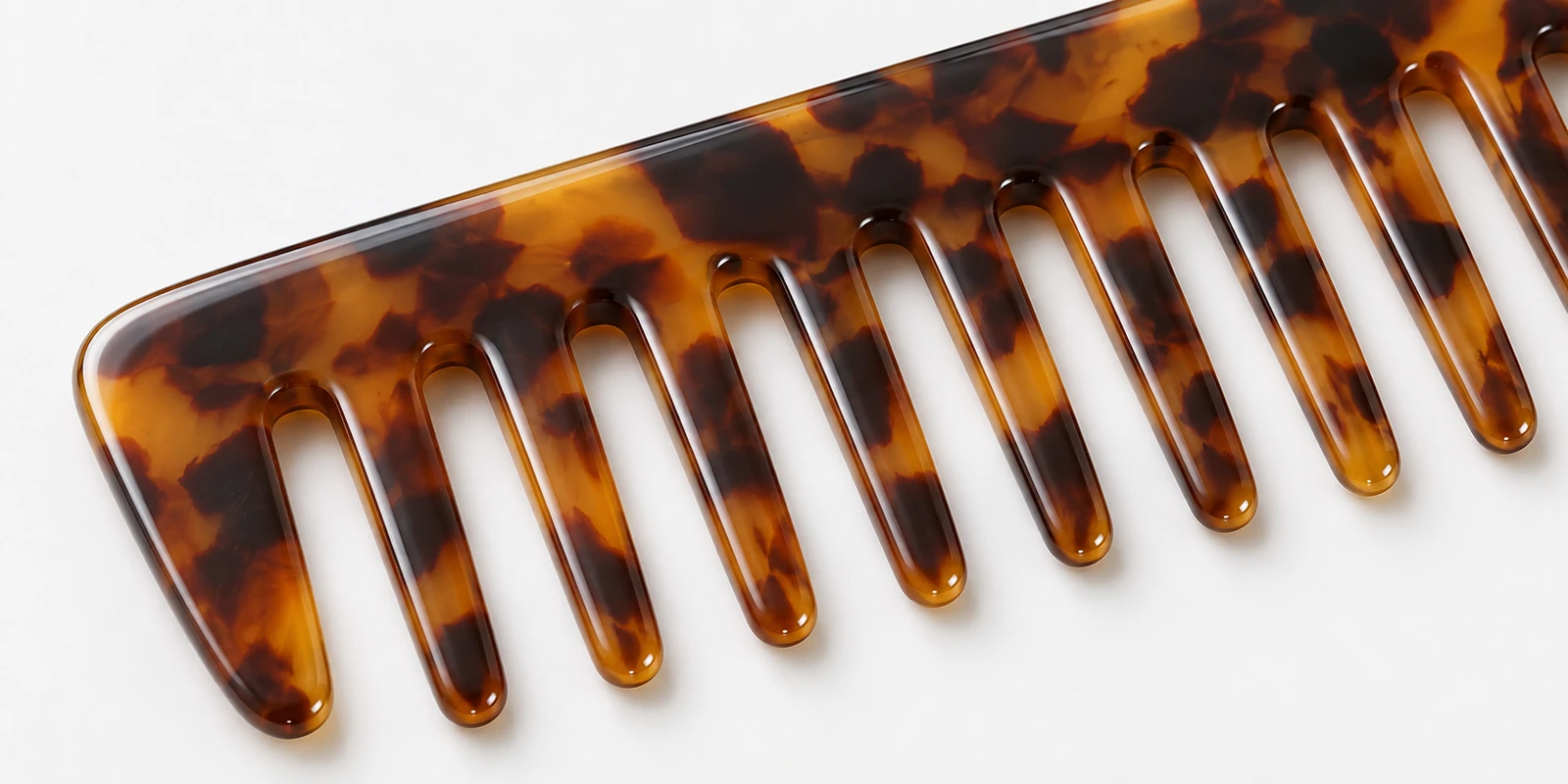 Seamless-finished acetate curl defining comb showing smooth tooth edges for wet styling use