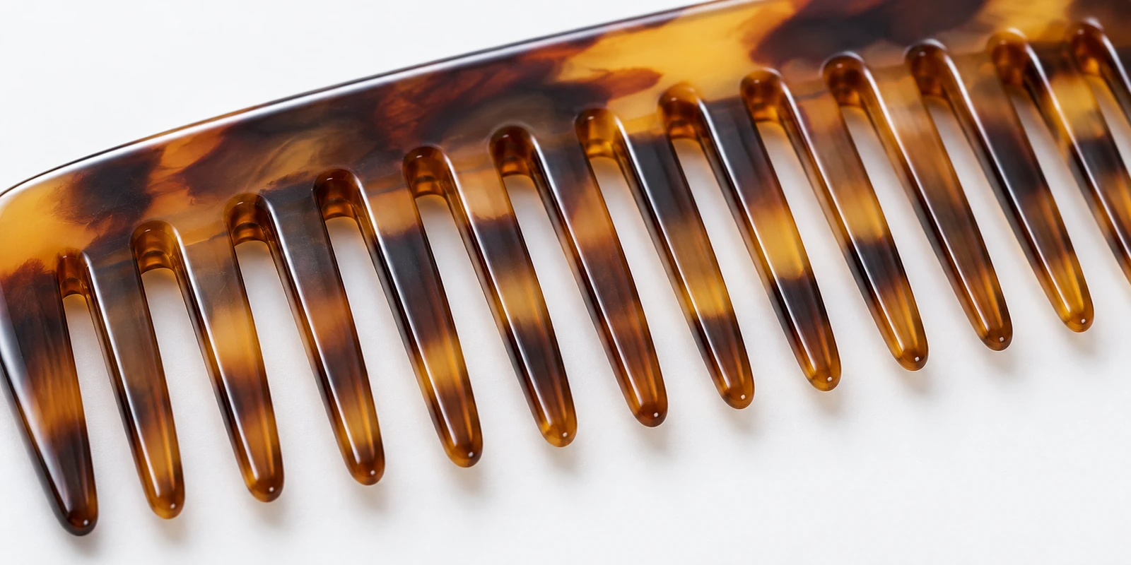 Close-up of sawcut comb tooth edges showing rounded polished finish from handmade production process